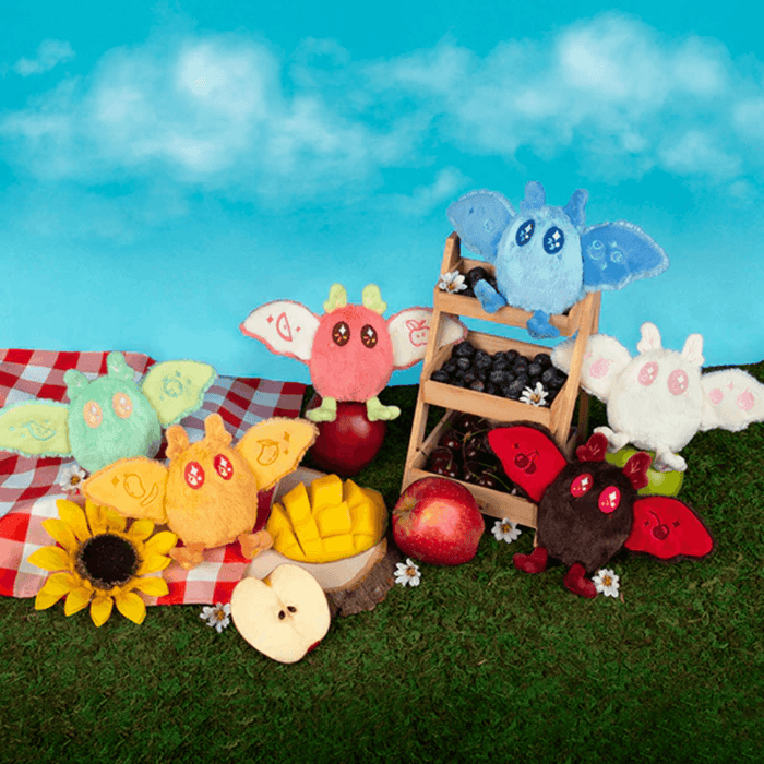 Squishable Baby Mothman Fruit Stand plush keychains displayed with fruit stand scene