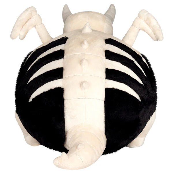 Back view revealing rib-like stripes, wings and tail on the Bone Dragon plush.