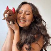 Woman cuddling the Squishable Alter Egos Cocoa Kitsune plush toy