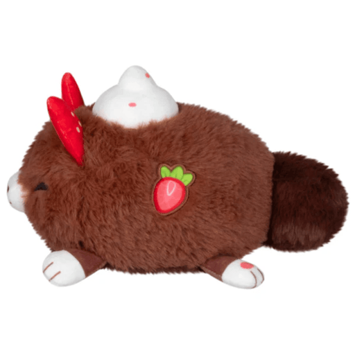 Side view of the Cocoa Kitsune plush showing its embroidered strawberry detail