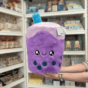 Squishable Comfort Food Bubble Tea plush toy held in hands in a gift shop, front view