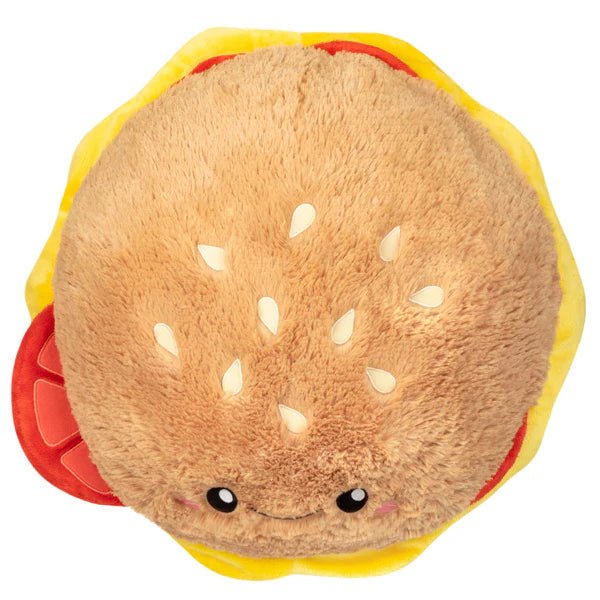 Top view of the Squishable Cheeseburger plushie showing sesame seed details and bun texture.