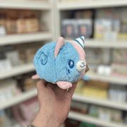 Side view of Squishable Alter Egos Cotton Candy Kitty plushie showing its blue fur, pink ears and soft pastel body