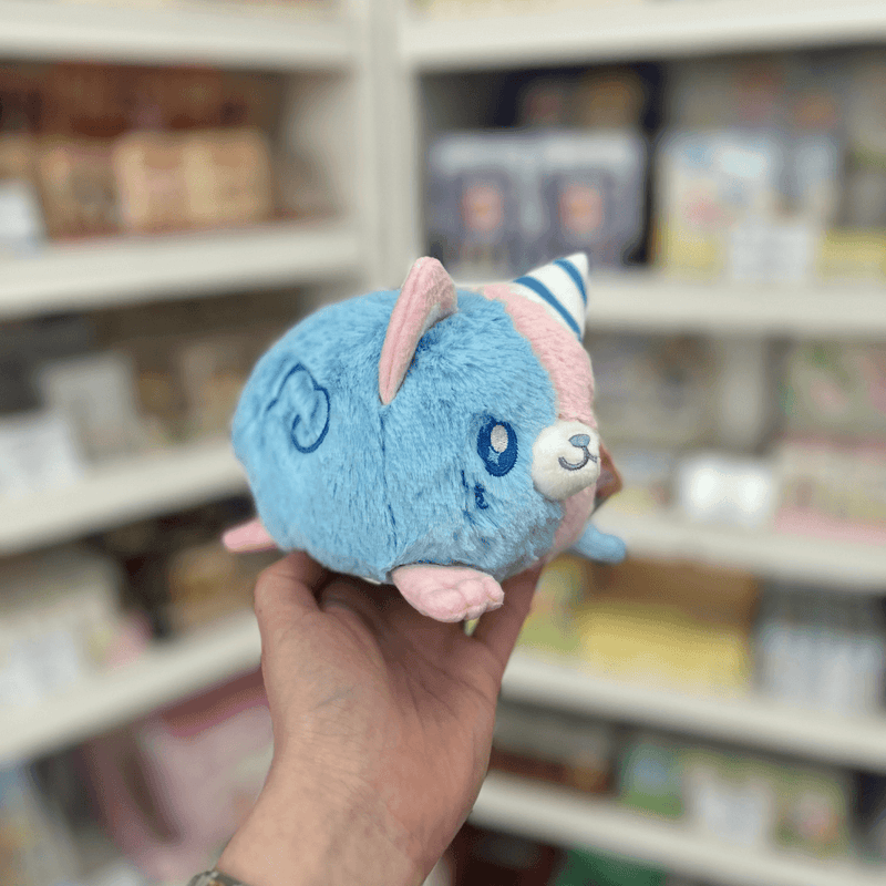 Side view of Squishable Alter Egos Cotton Candy Kitty plushie showing its blue fur, pink ears and soft pastel body