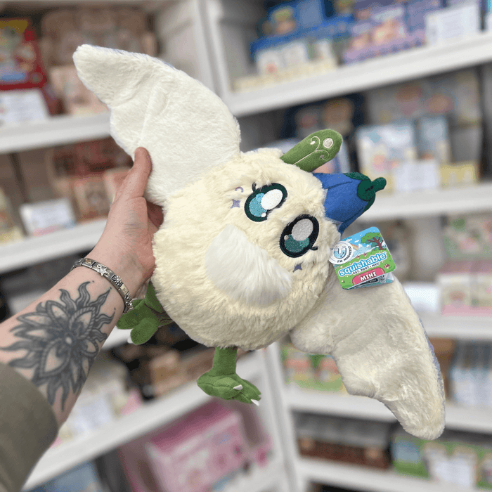 Mini Squishable Fairy Baby Mothman plush toy with wings spread, embroidered eyes, blue hat and official Squishable tag
