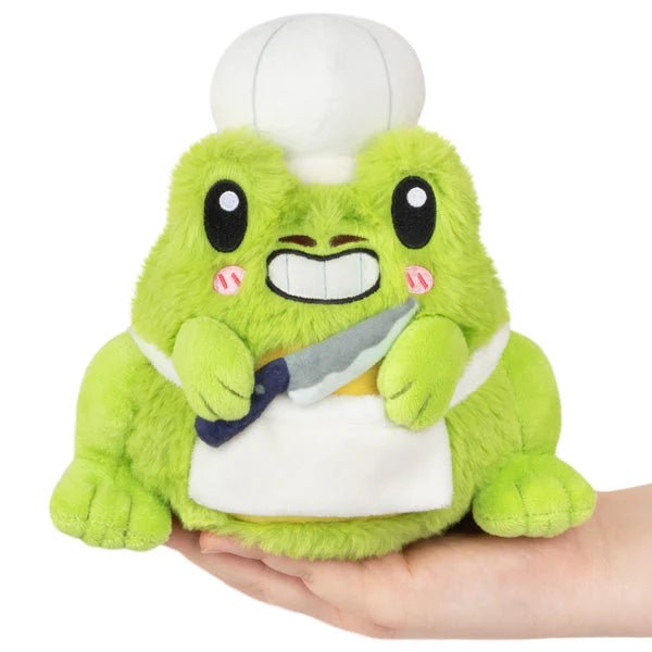 Front view of Squishable Frog Chef plushie holding a plush knife and smiling