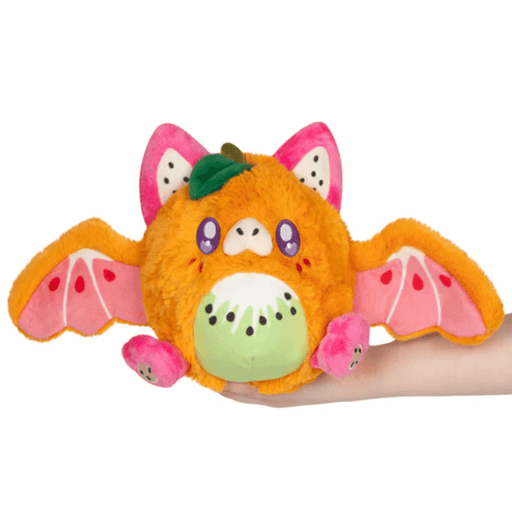 Front view of Mini Squishable Fruit Bat plush with orange fur, pink wings and kiwi belly