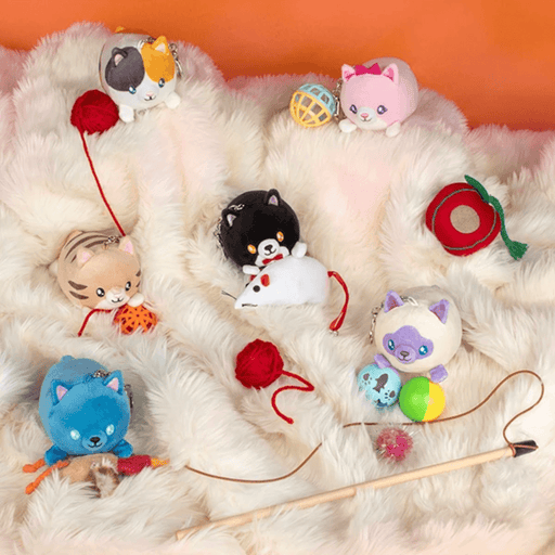 Squishable Cozy Cats miniature plush keychains displayed together on a fluffy blanket