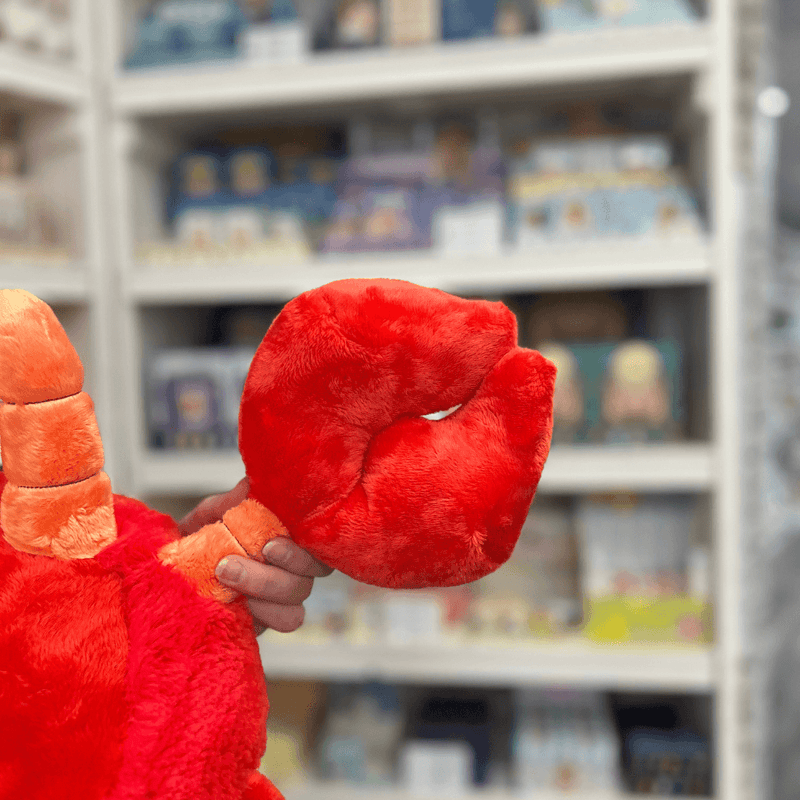 Squishable Lobster plush toy claw close-up in a gift shop, closed detail