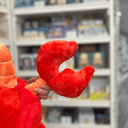 Squishable Lobster plush toy claw close-up in a gift shop, open detail