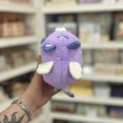 Back view of Squishable Alter Egos Magical Kitty plush showing its purple body, white wings and blue tail tip