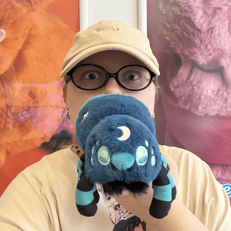 Person holding the Squishable Alter Egos Midnight Spider plush toy
