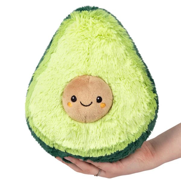 Front view of Mini Squishable Avocado plushie with smiley pit and soft green texture

