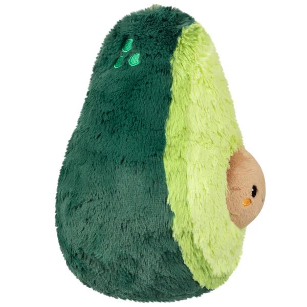 Side view of Squishable avocado plushie with embroidered details and rounded shape

