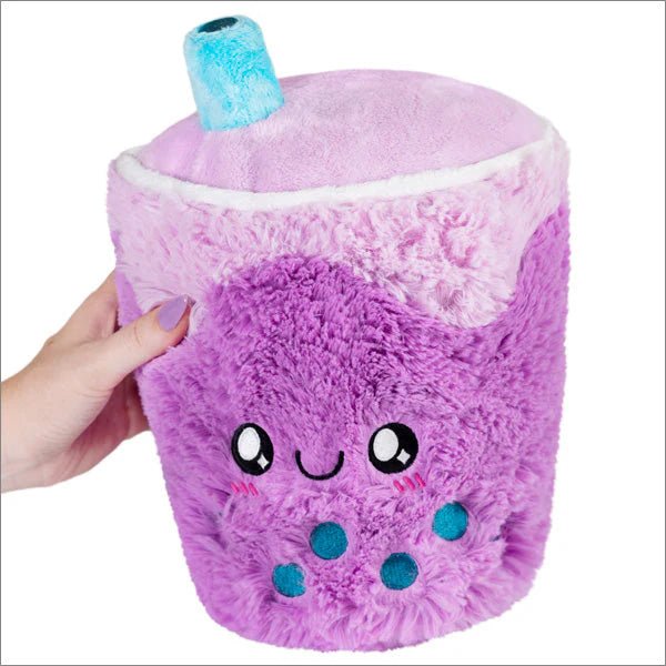 Front view of Squishable Mini Bubble Tea plushie with smiling face and blue boba pearls

