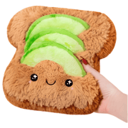 Mini Squishable Comfort Food Avocado Toast plush toy held in hand against a plain light background