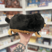 Mini Squishable Fluffy Dachshund plush toy held in hand in a gift shop, back view