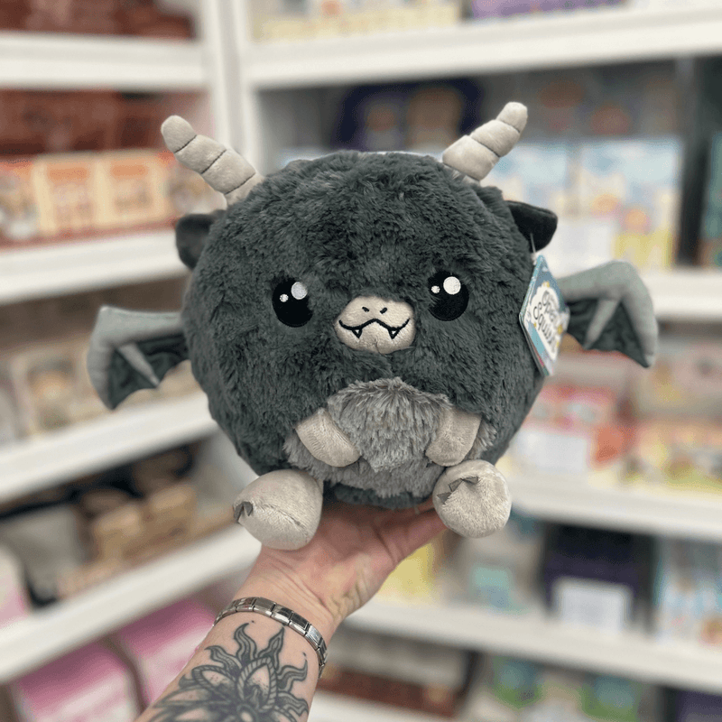Mini Squishable Gargoyle plush toy held in hand in a gift shop, front view
