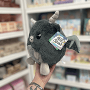 Mini Squishable Gargoyle plush toy held in hand in a gift shop, side view