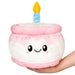 Front view of Squishable Mini Happy Birthday Cake plushie with pink icing and smiling face

