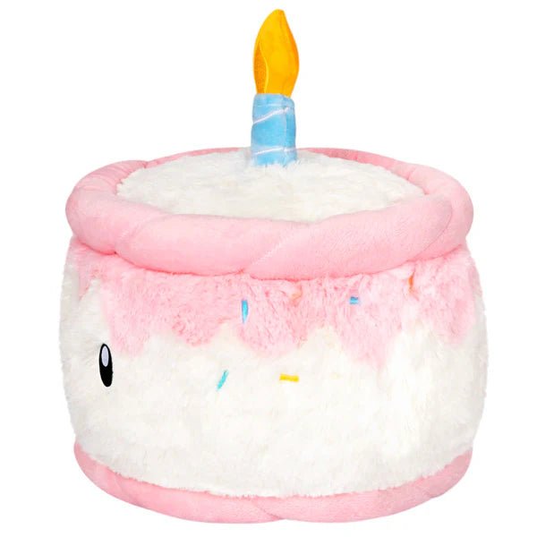 Side view of plush birthday cake with blue candle and colourful sprinkles

