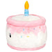 Side view of plush birthday cake with blue candle and colourful sprinkles

