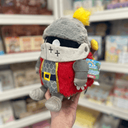 Mini Squishable Knight plush toy held in hand in a gift shop, angled side view
