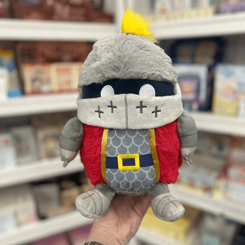 Mini Squishable Knight plush toy held in hand in a gift shop, front view