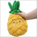 Front view of Squishable Mini Pineapple plushie with cute embroidered face
