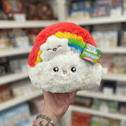 Mini Squishable Rainbow plush toy held in hand in a gift shop, front view