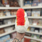 Mini Squishable Rainbow plush toy held in hand in a gift shop, side view
