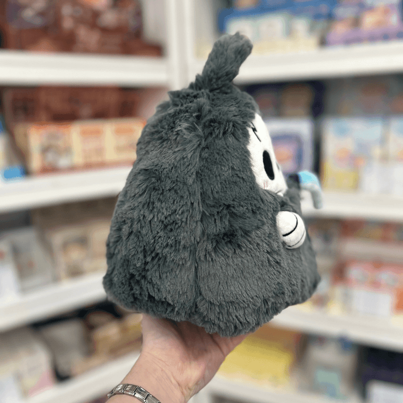 Mini Squishable Reaper plush toy held in hand in a gift shop, angled back view