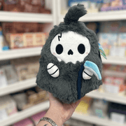 Mini Squishable Reaper plush toy held in hand in a gift shop, front view