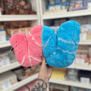 Mini Squishable Sour Gummy Worm plush toy held in hand in a gift shop, back view showing blue and pink sections
