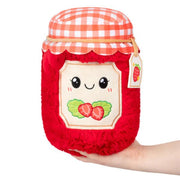 Front view of Squishable Mini Strawberry Jam plushie with smiling face and gingham lid

