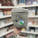 Mini Squishable Trash Can plush toy held in hand in a gift shop, side view