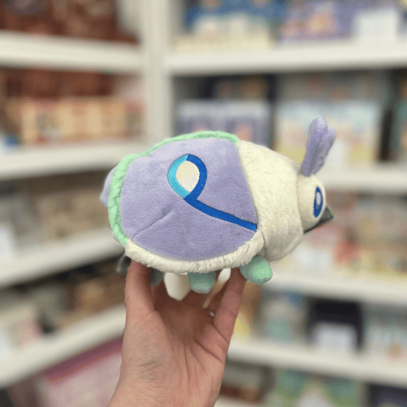 Squishable Party Snacker Lilac Luna Moth plush toy held in hand, side view