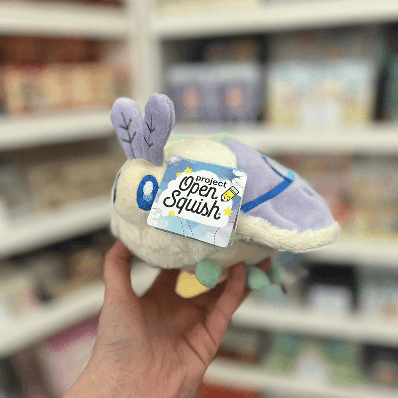 Squishable Party Snacker Lilac Luna Moth plush toy held in hand with tag visible