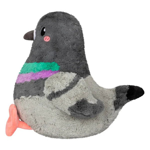 Side profile of the Squishable Pigeon plush toy with pink cheeks, black-tipped tail, and folded wings.