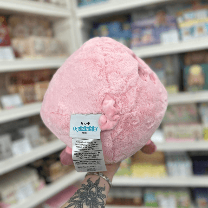 Back view of Squishable Piggy plush toy showing its soft pink fluffy body, little curly tail and official Squishable label