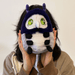 Person holding Squishable Plague Doctor Bug plush with purple hood and green eyes