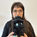 Person holding Squishable Plague Doctor Void plush with teal eyes and lantern