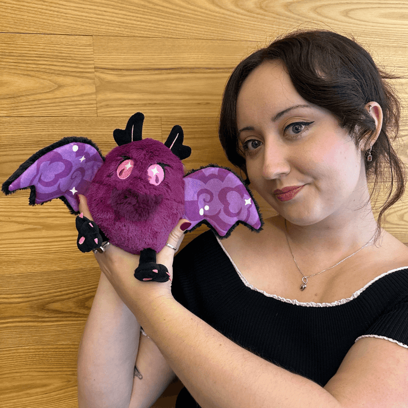 Squishable Alter Egos Poison Mothman plush being held