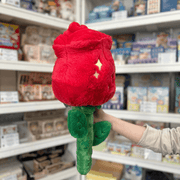 Squishable Red Rose plush toy side back view held in hand in a shop