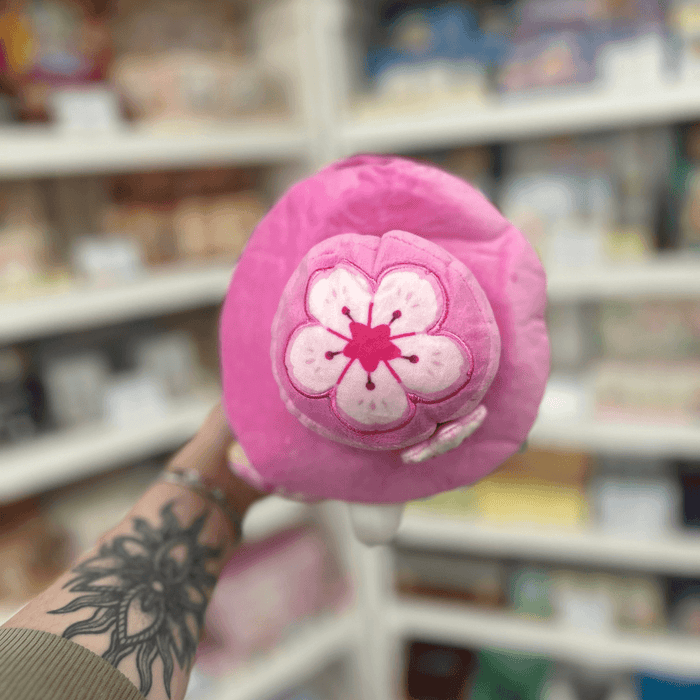 Close-up of Mini Squishable Sakura Plague Doctor plush toy showing the pink floral hat and cherry blossom detail