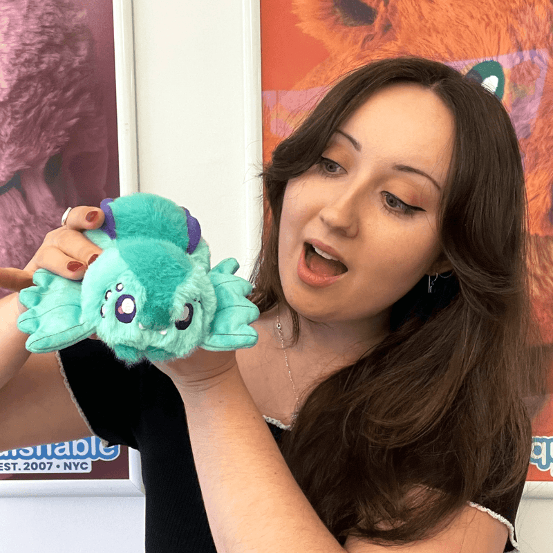 Woman holding the Squishable Alter Egos Sea Slug Spider plush toy