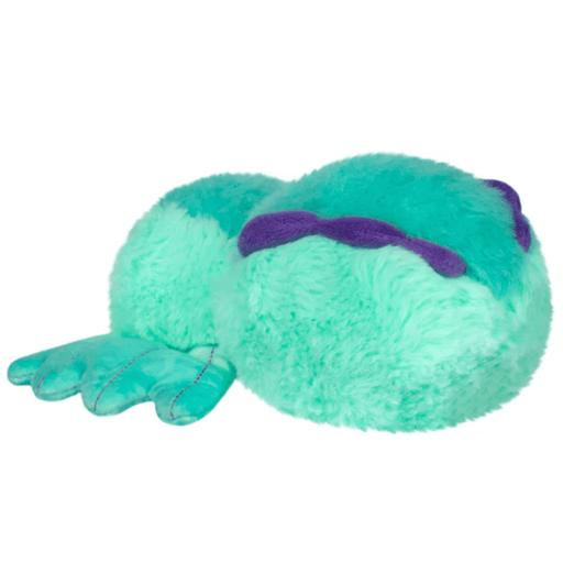 Side view of the Sea Slug Spider plush showing its soft aqua body and purple details