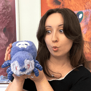 Woman holding the Squishable Alter Egos Skull Spider plush toy