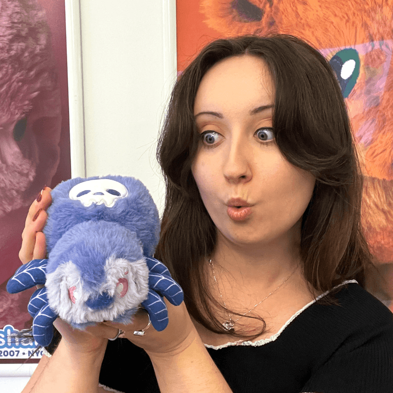 Woman holding the Squishable Alter Egos Skull Spider plush toy