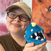Squishable Snacker Anglerfish plush being held